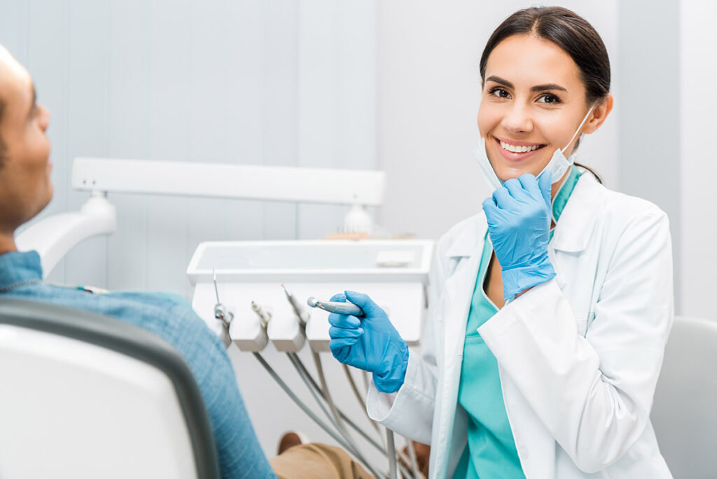 Female dental expert treating patient